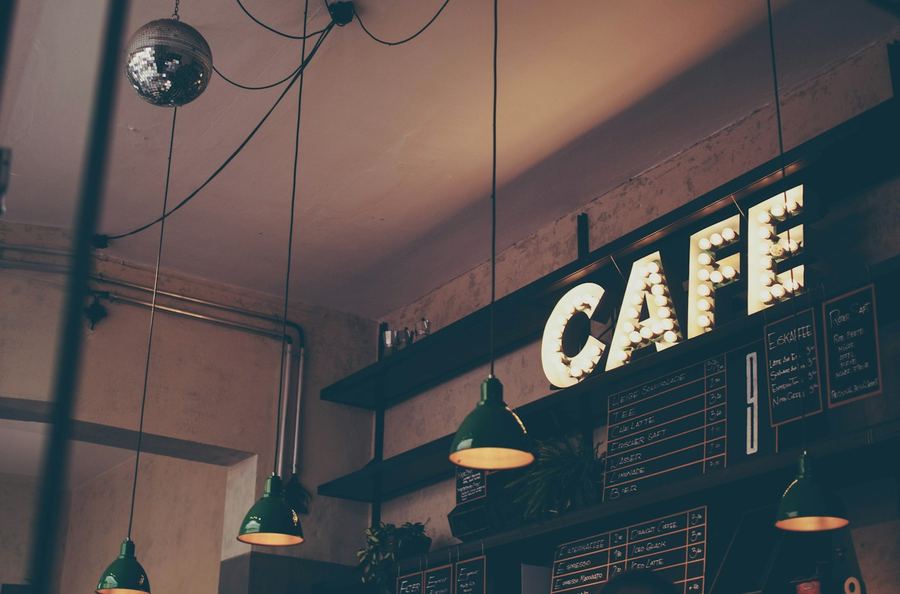 Neighbourhood cafe with lit cafe sign