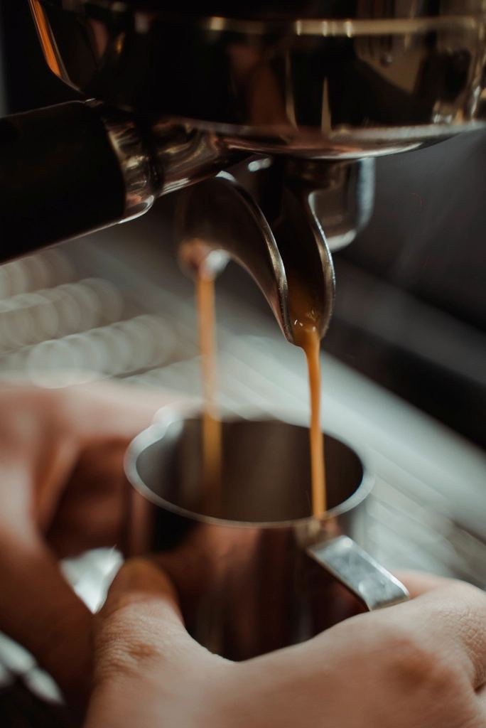 Espresso extracting from a portafilter