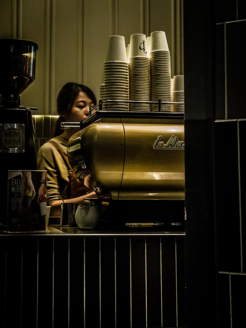 Barista working at a cafe espresso bar